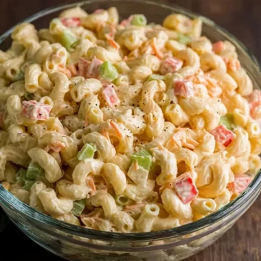 Small macaroni salad served in a bowl with colorful vegetables