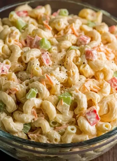 Small macaroni salad served in a bowl with colorful vegetables