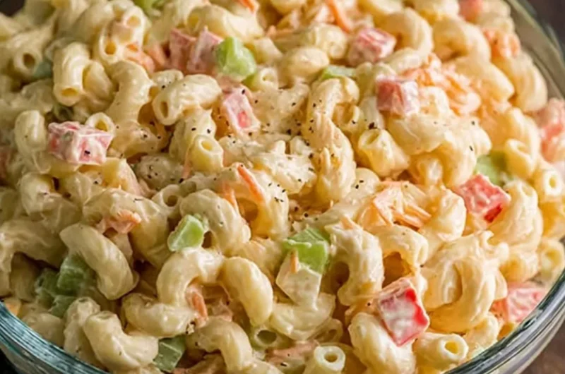 Small macaroni salad served in a bowl with colorful vegetables