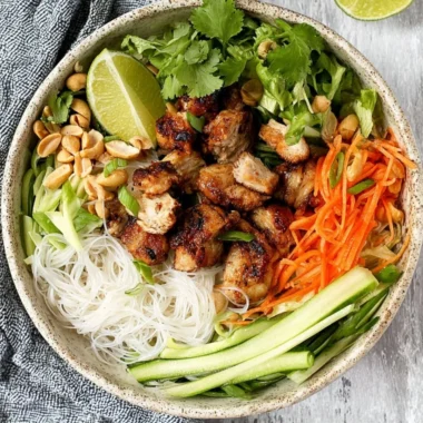 Vietnamese noodle bowl with lemongrass chicken served with fresh herbs and veggies