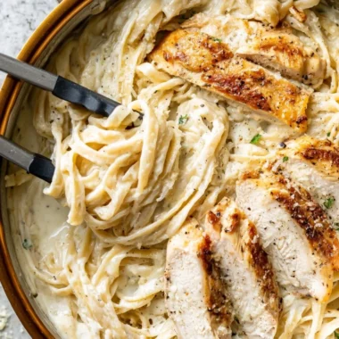Delicious plate of Chicken Fettuccine Alfredo with creamy sauce and grilled chicken