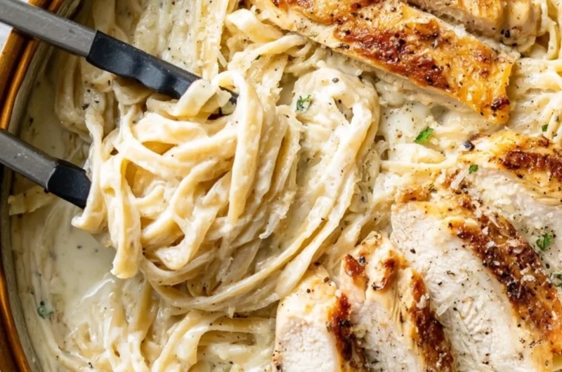 Delicious plate of Chicken Fettuccine Alfredo with creamy sauce and grilled chicken